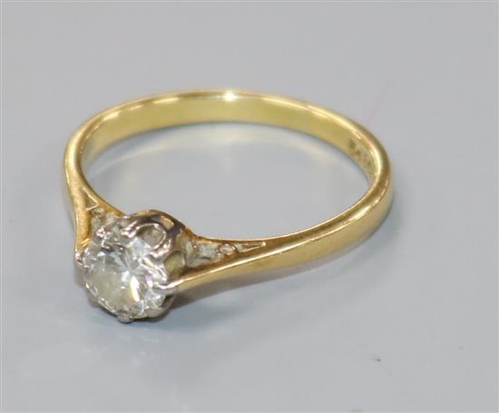 An 18ct gold and platinum set solitaire diamond ring, size K.